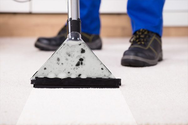 Carpet cleaning wand on light carpet