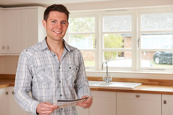 Real estate agent holding a home listing brochure